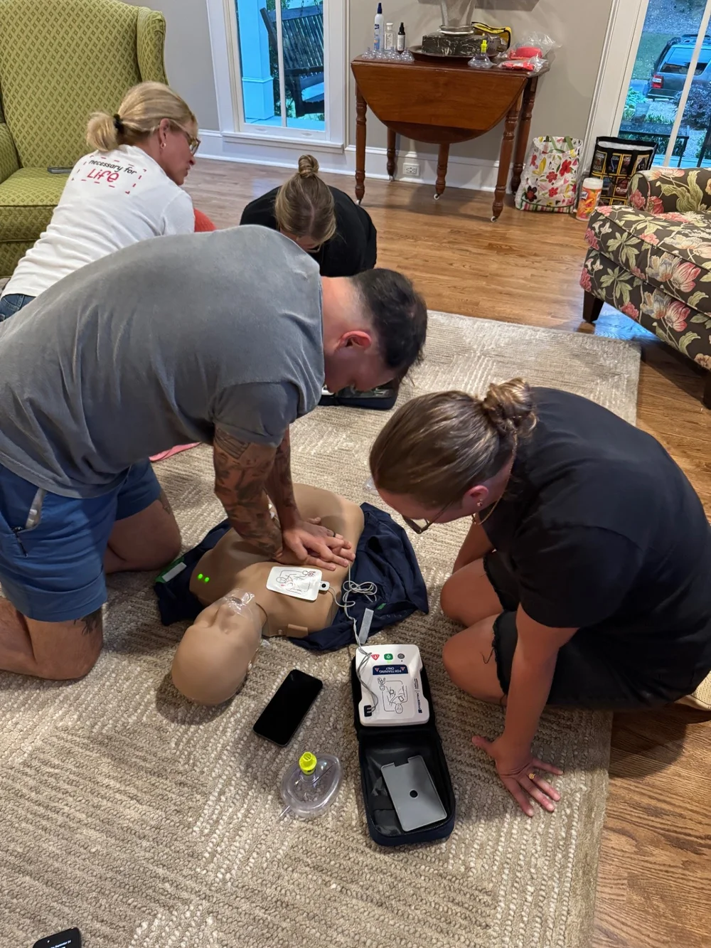 Participants practicing CPR on a manikin